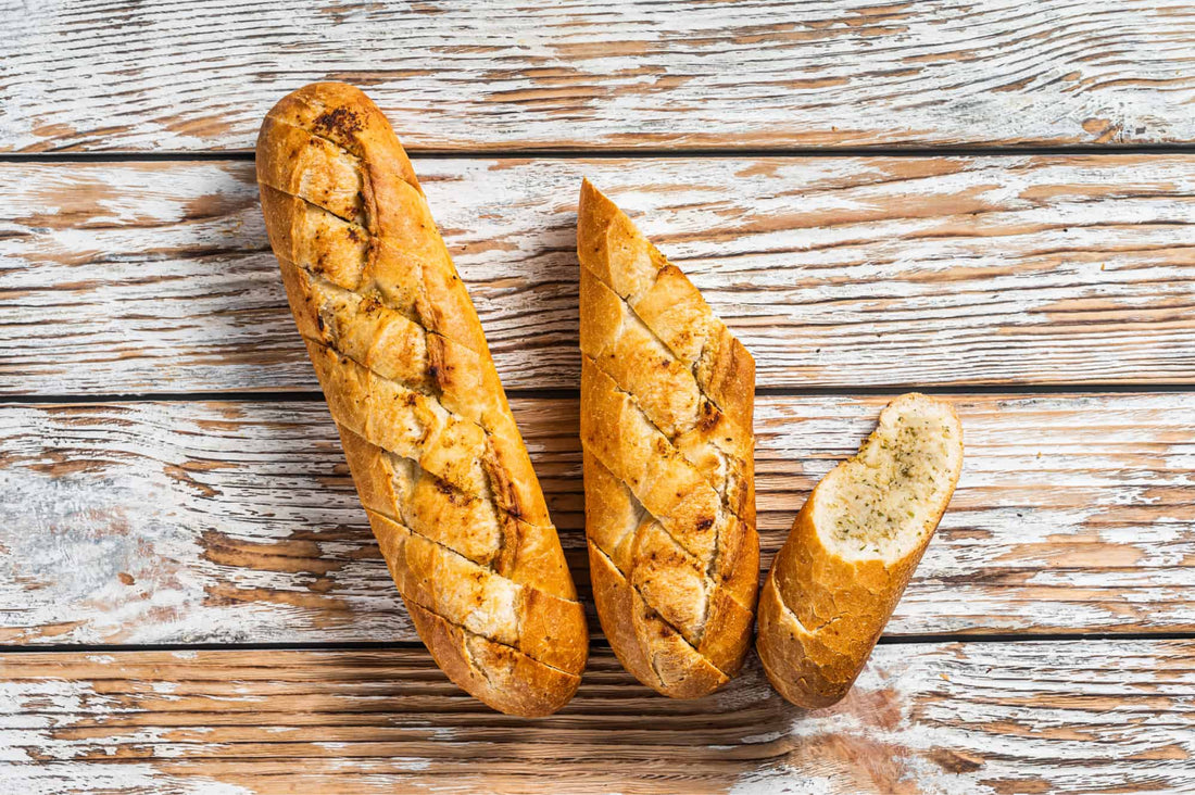 two low carb garlic baguettes on a wooden table
