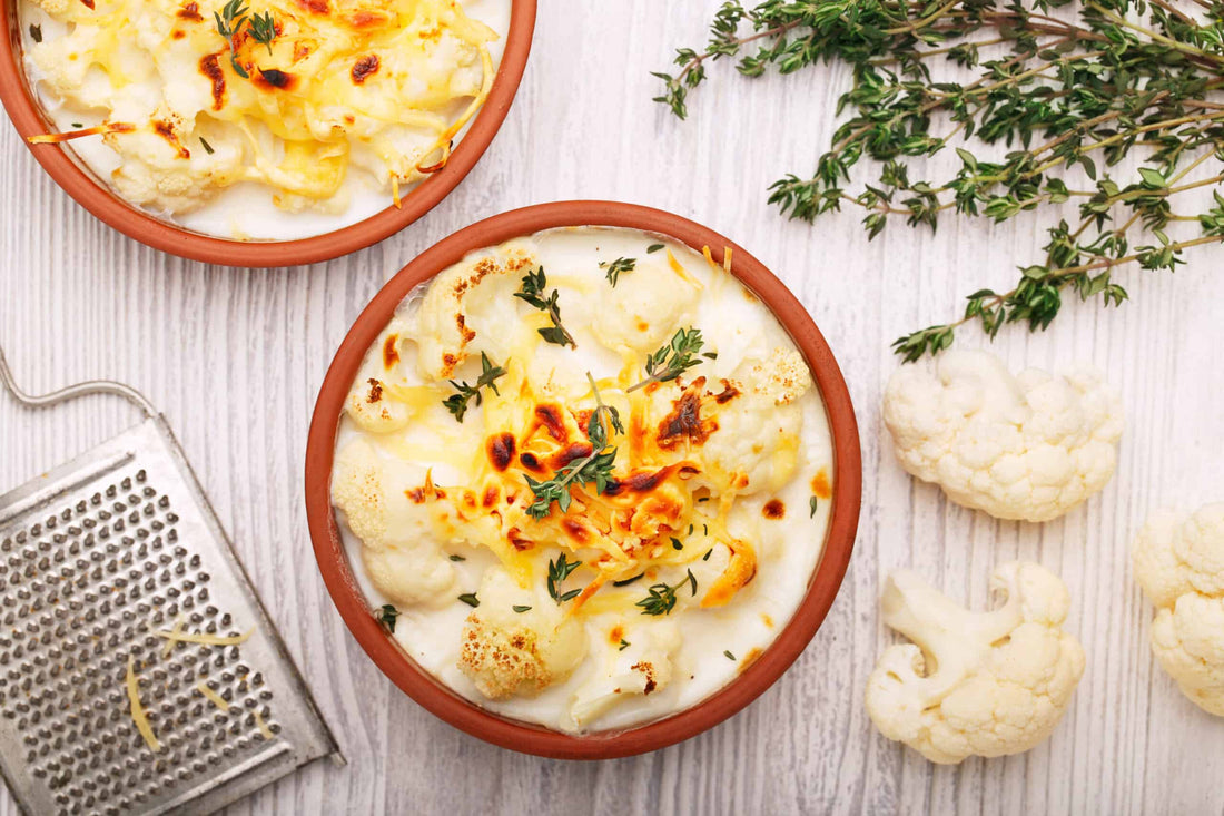 low-carb cauliflower cheese in a terracotta plate