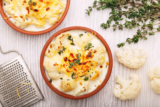 low-carb cauliflower cheese in a terracotta plate