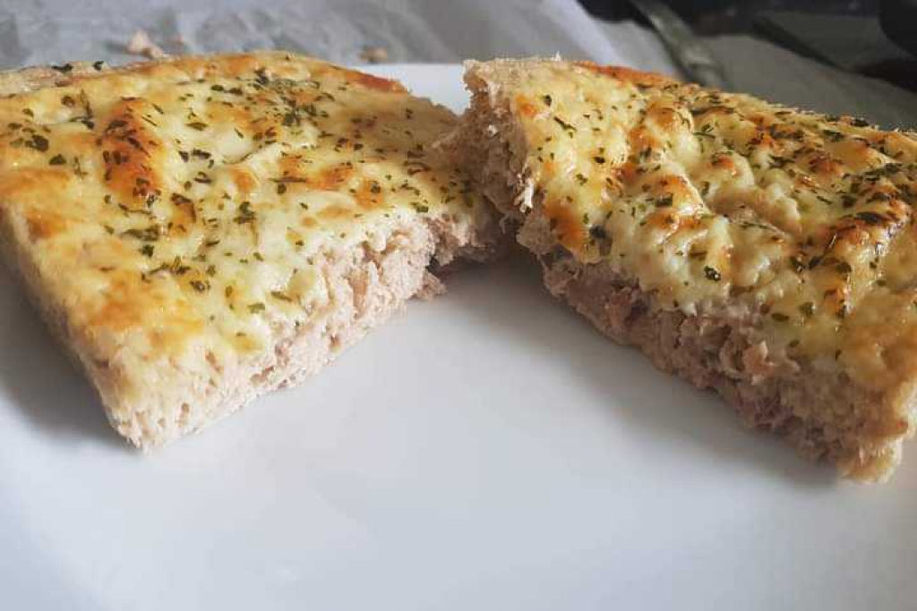 low-carb tuna bread cut in half and placed on a white plate