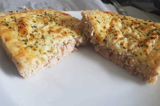 low-carb tuna bread cut in half and placed on a white plate