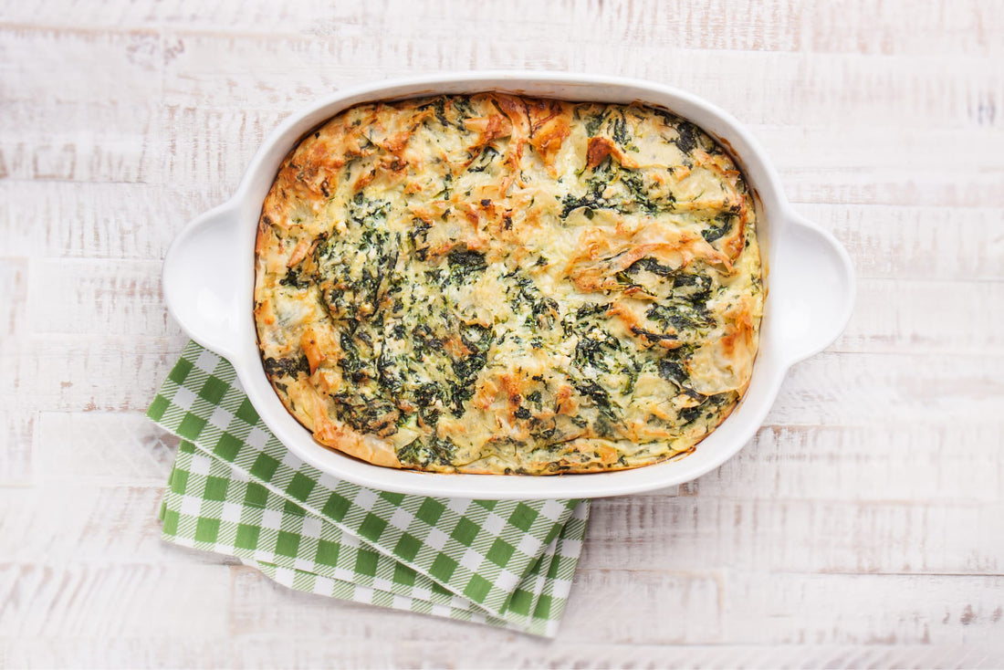 Low-carb chicken and broccoli casserole topped with melted cheddar in a baking dish.