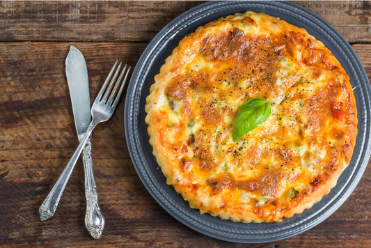 Low-carb quiche with a golden almond flour crust and a slice removed from the dish.