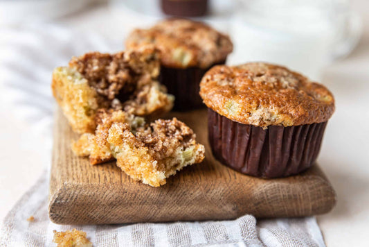 Low-carb apple breakfast muffins in paper cases cooling on a wire rack.