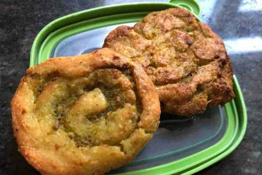 Low-carb pesto swirls on a baking tray showing the spiral of green pesto.