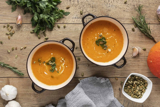 Bowl of low-carb spicy pumpkin soup topped with chopped chorizo.