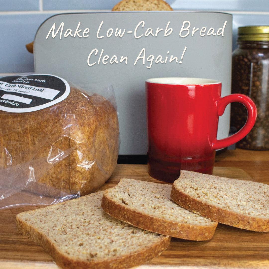 Packaged low-carb bread loaf with three slices, a red mug, and a toaster on a wooden counter.