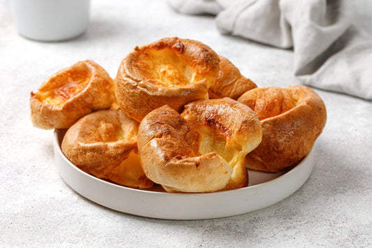 six low carb yorkshire puddings on a white ceramic plate